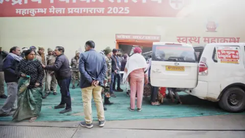 Ankit Srinivas Officials standing outside a temporary hospital at the Kumbh Mela in Prayagraj city.