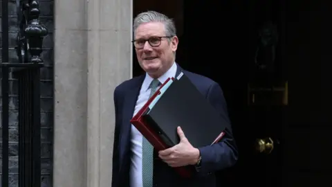 Getty Images Keir Starmer outside Downing Street holding a folder