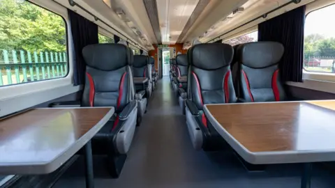 A train carriage with tables and chairs 
