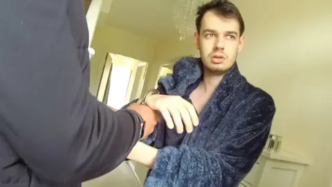 Leicestershire Police Tyler Webb in a dressing gown being arrested by police