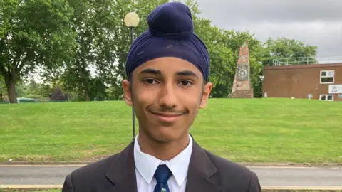 Manroop, a student from Wootton Upper School standing outside the school 