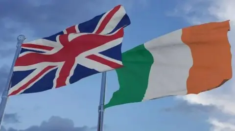 Getty Images A Union flag and Irish tricolour flying beside each other on separate flag poles