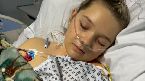 Family photo Isla asleep in hospital