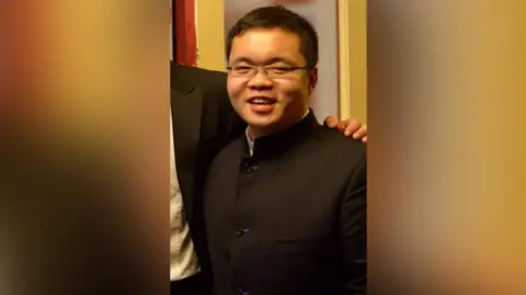 Peter Cui Peter Cui in a smart black jacket, shown during university days 