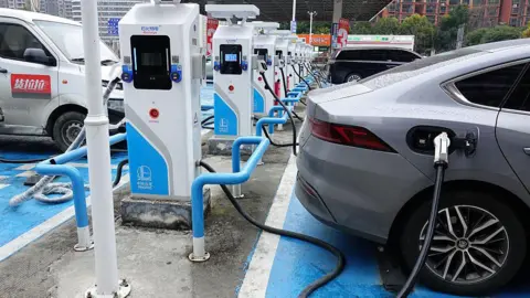Getty Images An electric vehicle charges at a charging station 