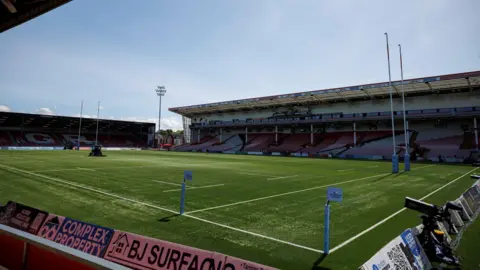 Getty Images A side view of the pitch and stands at Kingsholm stadium in Gloucester. It is a sunny day and the stands are empty
