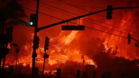  Flames overtake an intersection in Pacific Palisades on 7 January 2025.