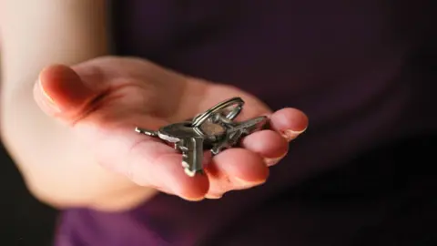 Getty Images A stock image of someone holding a set of house keys.