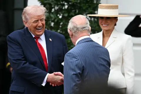 AFP via Getty Images US President Donald Trump and First Lady Melania Trump, greet Britain's King Charles III during an arrival ceremony on the South Lawn of the White House in Washington, DC, on April 28, 2026.