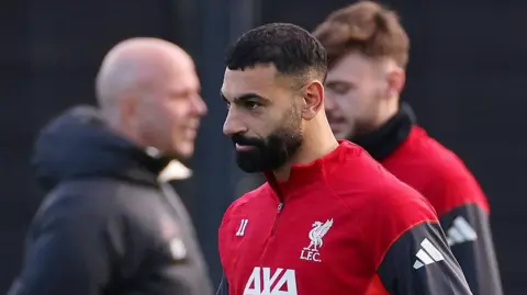 Mohamed Salah wearing a Liverpool training top