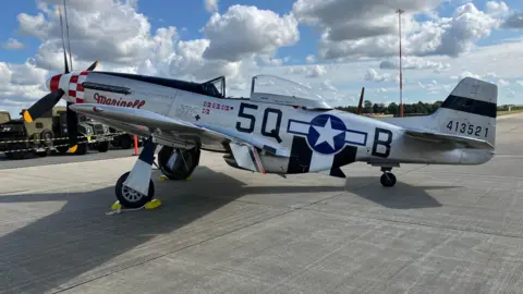 A P51 Mustang long-range fighter plane sat on the runway