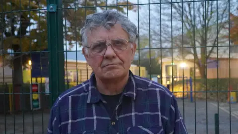 Local Democracy Reporting Service Andrew McCulloch, with short grey hair and glasses, looking directly into the camera.