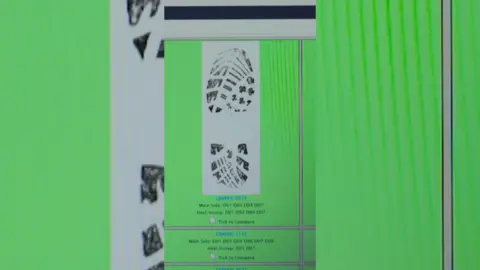 Image of a footprint in a white square on a green computer screen.