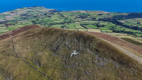 Manx scenes A drone view shows the Manx logo in white on a hillside overlooking the west side of the Isle of Man 