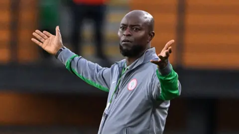 Finidi George gesticulates on the touchline during Nigeria's defeat against Benin