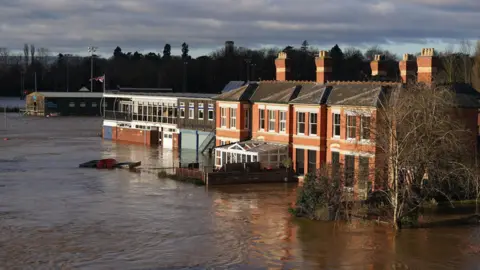 PA Media Flooded buildings next to the River Wye in Hereford