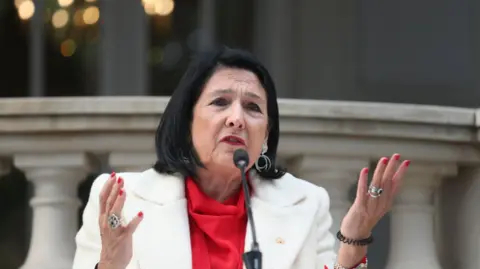 Reuters Outgoing Georgian President Salome Zourabichvili delivers a statement outside the Orbeliani Palace in Tbilisi, Georgia, 29 December 2024