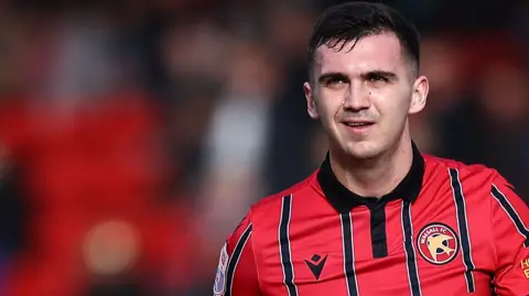 Oisin McEntee wearing a Walsall shirt