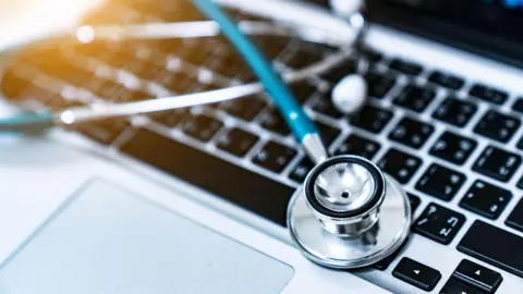 Getty Images Stock image of a stethascope placed on a laptop.