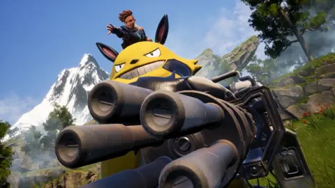 Pocketpair Screenshot shows a human character sitting on top of a large, yellow creature, riding in a large tank with five comedically large cannon emerging from the front of it. 