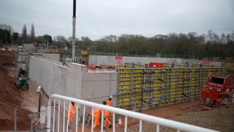 BBC A construction site, with the installation of large concrete pool located in the centre well under way.