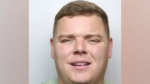 West Yorkshire Police A custody image of a man with short light brown hair who is staring straight ahead.