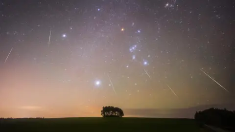 Dan Monk, Kielder Observatory A night sky showing shooting stars blaze a trail above the countryside