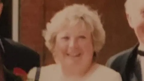 Family handout An old photograph of a woman with short blond hair wearing a white t-shirt