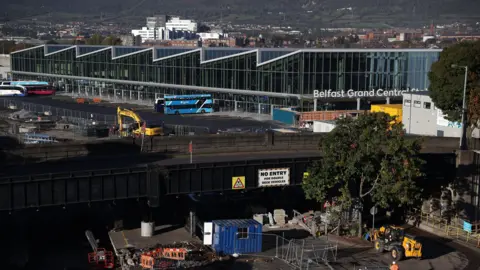 Liam McBurney/PA Wire An aerial view of Belfast's Grand Central Station and the Boyne Bridge at Durham Steet.  There are roadworks on and below the bridge which is in the process of being dismantled.  Central Station is a large, glass-fronted building with sloping roofs.