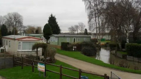 Burgess Von Thunen/Geograph Several static caravans in front of a river at Cogenhoe Mill Holiday Park