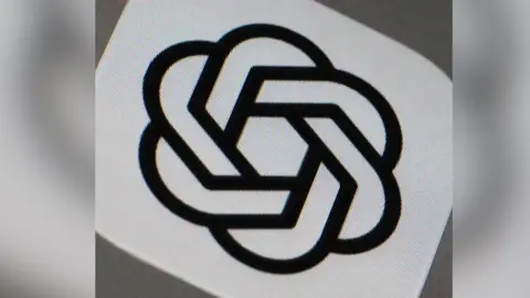 The ChatGPT logo. It looks like a number of chains all linked in a circle with each other.