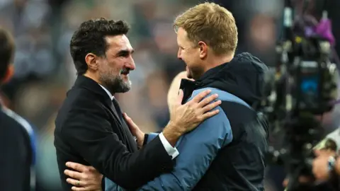 Yasir Al-Rumayyan greets Eddie Howe after Newcastle United qualify for the Champions League following a goalless draw against Leicester City at St James' Park on 22 May, 2023