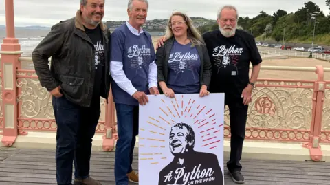 Terry's children Bill Jones and Sally Jones with Michael Palin and Terry Gilliam on Colwyn Bay pier