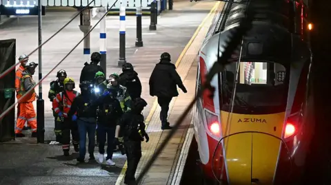 Emergency services next to a train.