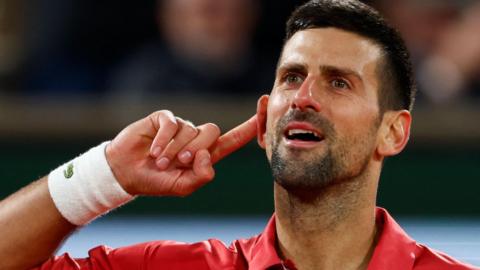 Novak Djokovic celebrates winning a point against Lorenzo Musetti