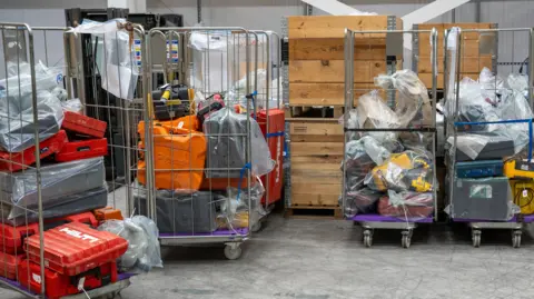 Met Police Stacked up boxes of tools wrapped up in plastic bags in cages. Six cages can be seen here awaiting to be identified by police.
