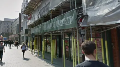 Google Image shows scaffolding surrounding the outside of a Holland & Barrett store in Liverpool. It is on a pedestrianised area in the city centre.