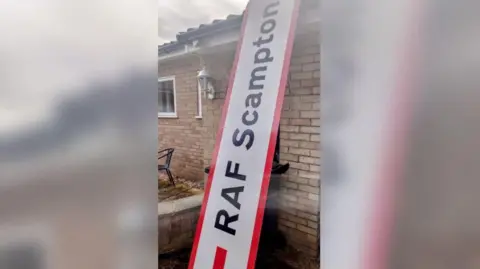 Steve Jollands The RAF Scampton sign propped up against the side of Steve Jollands's bungalow to show it is higher