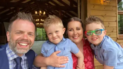 Family Handout Aimi with her husband and boys