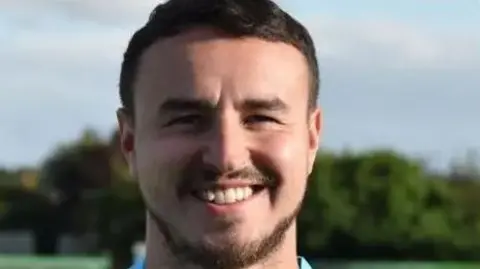 Barton Town FC James Hitchcock, who is a white man in his 30s with brown hair and a beard