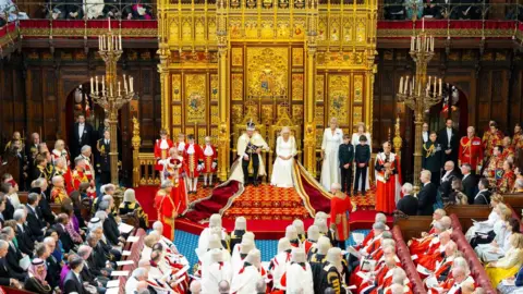 House of Lords/Roger Harris King Charles with Queen Camilla at the State Opening of Parliament in the House of Lords