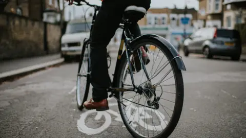 Getty Images Man on bike in street