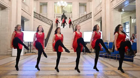 Michael Cooper Pictured at an event in the Great Hall, Parliament Buildings to mark Fleadh Cheoil na hÉireann 2026 were the Assembly Speaker, Edwin Poots MLA with Laila Hendrick from the Ballynafeigh Irish Dance School, Riley McAuley from the Belfast Bands Forum and Michael McErlane from Ards Comhaltas Ceoltóirí Éireann. 