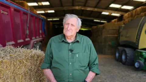 Michael Keohan/BBC Roy Glover a third generation farmer and butcher stands on his farm outside Dartford.