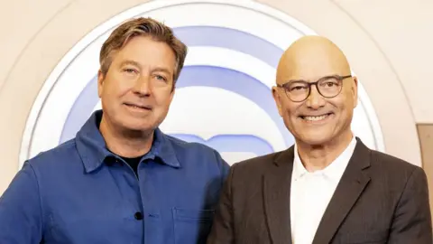 BBC/Shine TV John Torode and Gregg Wallace stand in front of the Masterchef logo as they promote series 19 of the show
