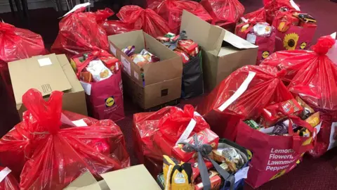 Salvation Army Presents wrapped in bags and placed in boxes