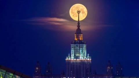  The moon pictured behind the tall spire of Lomonosov Moscow State University.
