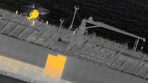 Infrared image of the Swedish coast guard boarding the Sea Owl One via helicopter in the Baltic Sea