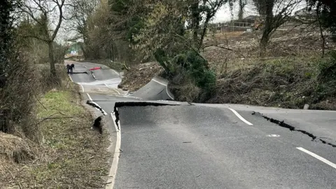 A wonky road with surface splits and rising parts