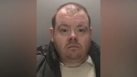 Leicestershire Police A police mugshot of John Siddell. He is pictured in front of a grey background